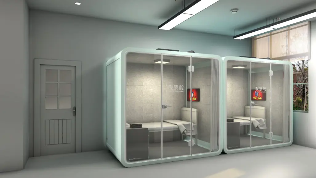 Two enclosed healthcare pods equipped with patient beds and glass doors