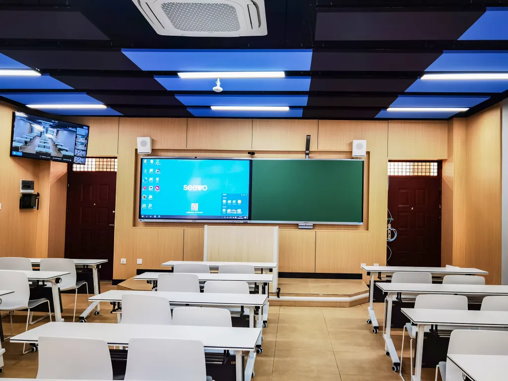 Classroom with acoustic ceiling panels and wall treatments for improved sound control