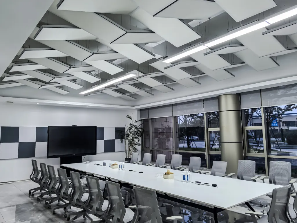 Modern conference room with Soundbox Imagine Acoustic Magic panels on the ceiling and behind the TV.