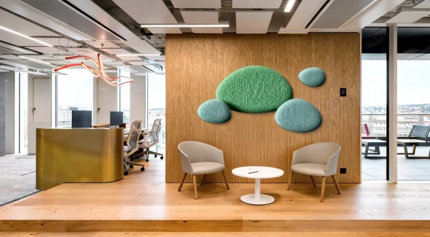 Decorative acoustic wall panels above a seating area in a modern office