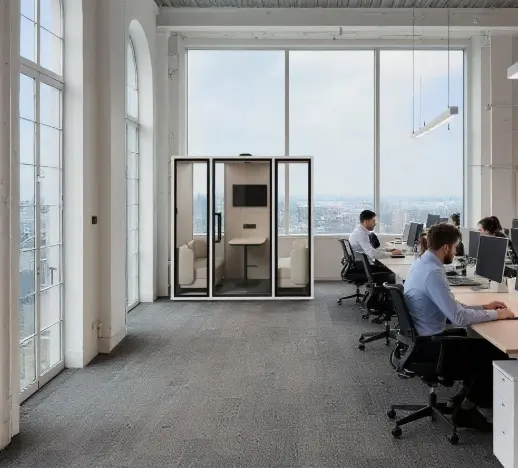 Soundbox VRT acoustic meeting pod with seating and a screen beside open office desks